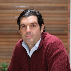 Headshot of Alejandro Betancourt López wearing a red sweater